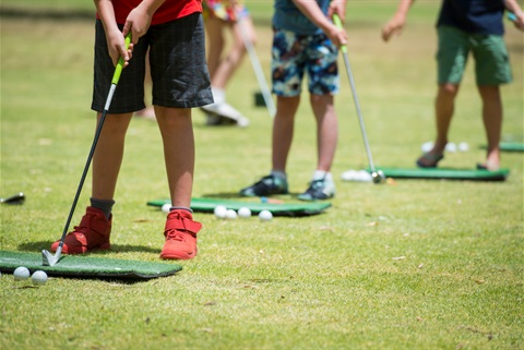 Children learning how to play golf